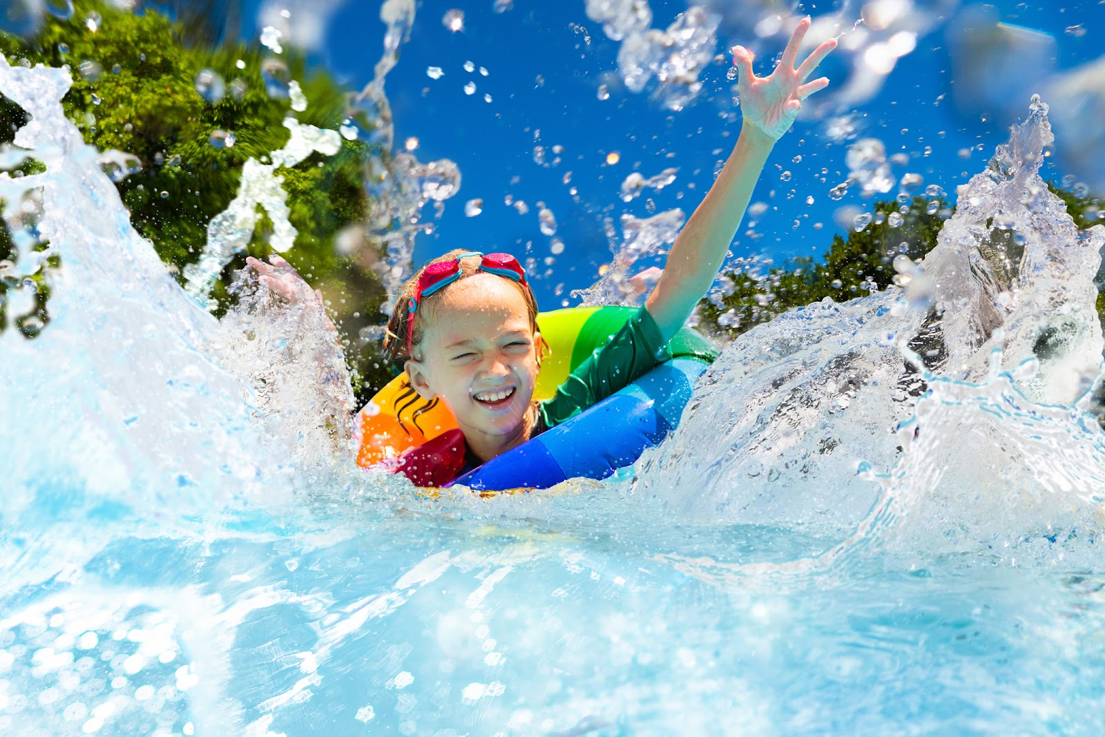A boy has fun in an above ground pool.