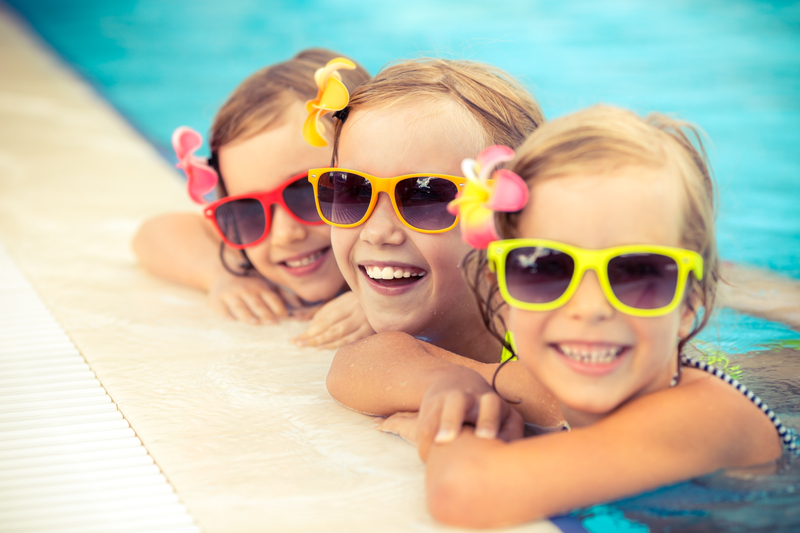3 girls in a swimming pool. Burton Pools & Spas is the pool store near me for trusted pool places.